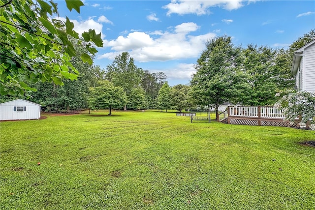 view of yard with a storage unit and a deck