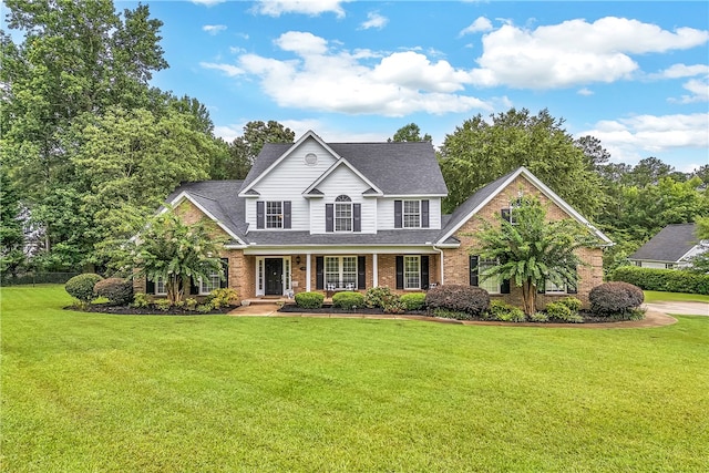 view of front of property with a front yard and covered porch