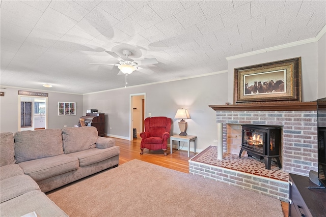 living room featuring light wood-type flooring, ceiling fan, and crown molding