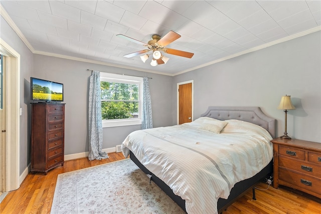 bedroom with ceiling fan, light hardwood / wood-style flooring, and ornamental molding