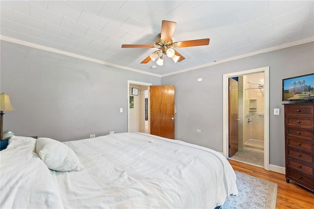 bedroom featuring light hardwood / wood-style flooring, ensuite bath, ceiling fan, and crown molding