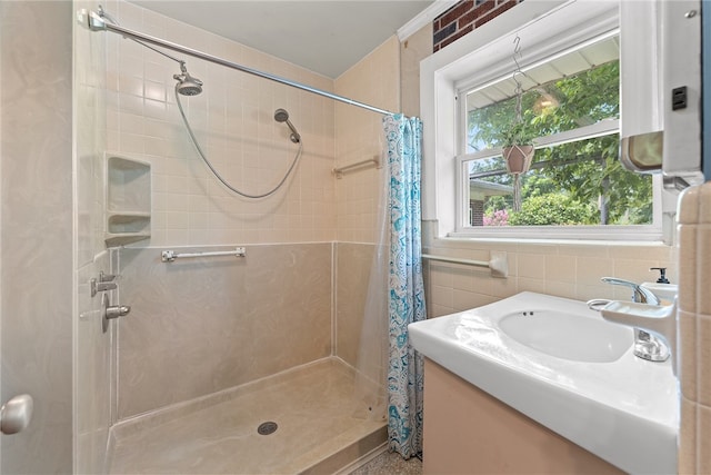 bathroom with tile walls, vanity, and curtained shower