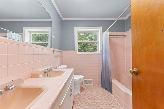 full bathroom featuring vanity, toilet, shower / bathtub combination with curtain, and a wealth of natural light