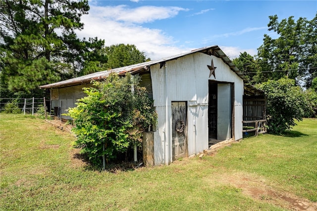 view of outbuilding featuring a yard