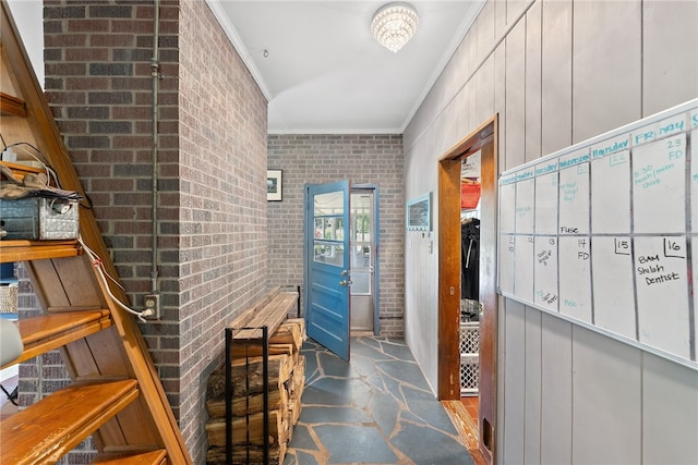 bathroom featuring ornamental molding and brick wall