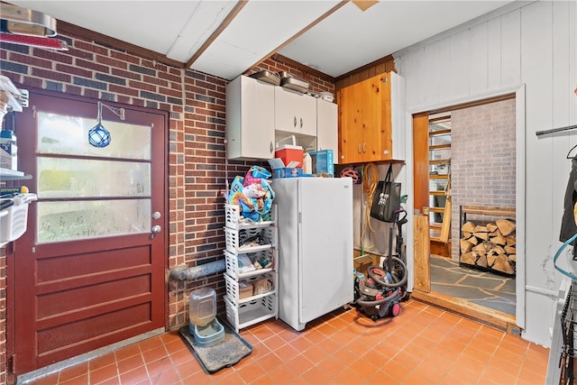 laundry room with brick wall, light tile patterned flooring, and wooden walls