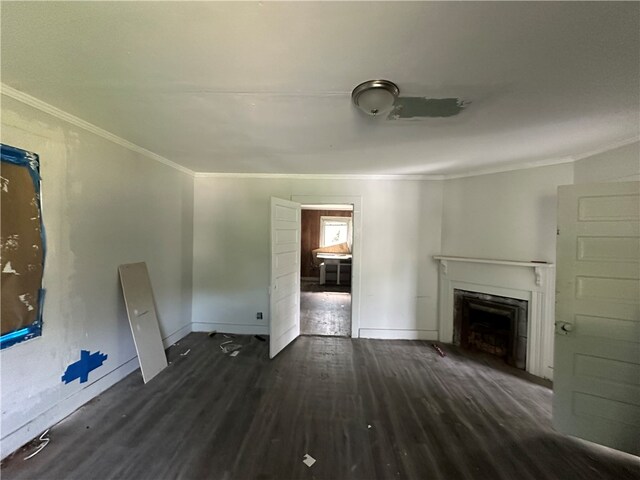 unfurnished living room with ornamental molding and dark hardwood / wood-style floors