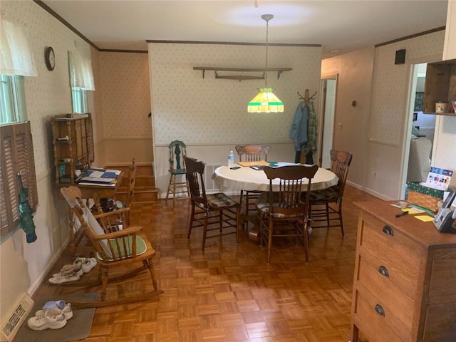 dining space featuring ornamental molding and light parquet floors