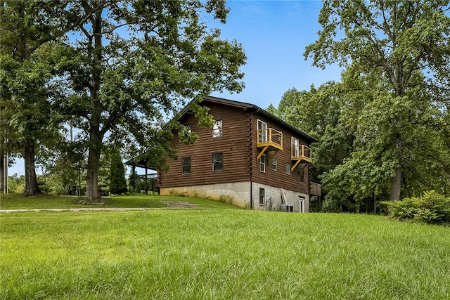 view of property exterior with a lawn and cooling unit