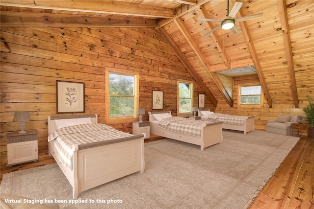 bedroom featuring vaulted ceiling with beams, wooden walls, light wood-type flooring, and wooden ceiling