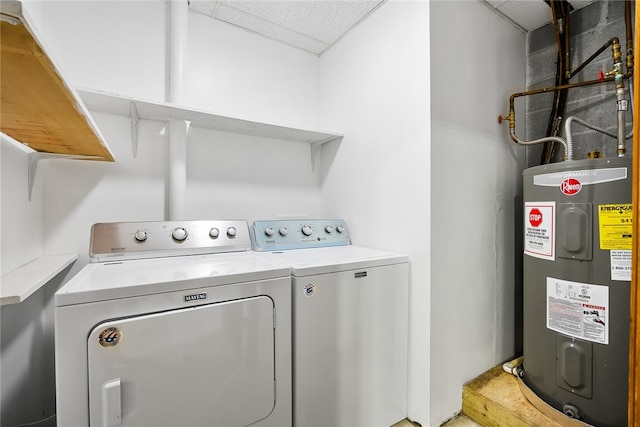 clothes washing area featuring water heater and independent washer and dryer