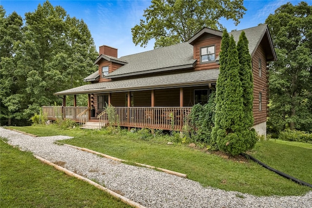 back of property featuring a lawn and a wooden deck