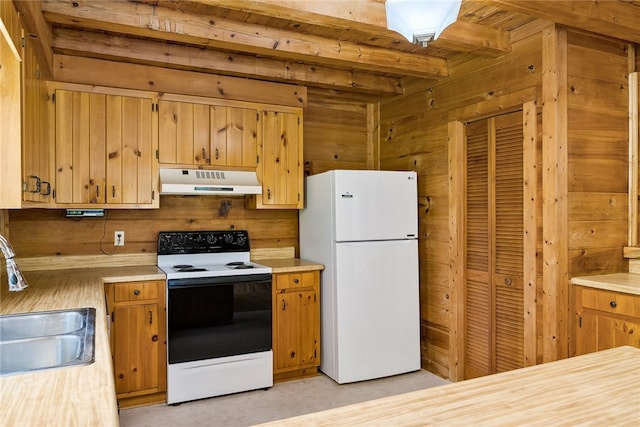 kitchen with wooden walls, beam ceiling, sink, and white appliances