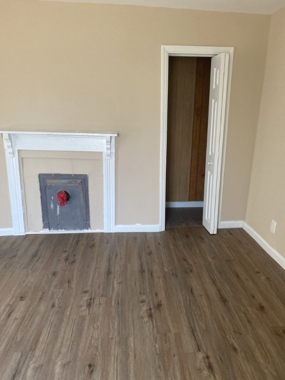 unfurnished living room featuring dark hardwood / wood-style floors