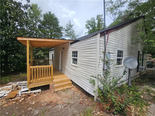 view of side of property with a wooden deck