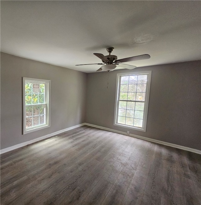 empty room featuring ceiling fan and dark hardwood / wood-style flooring