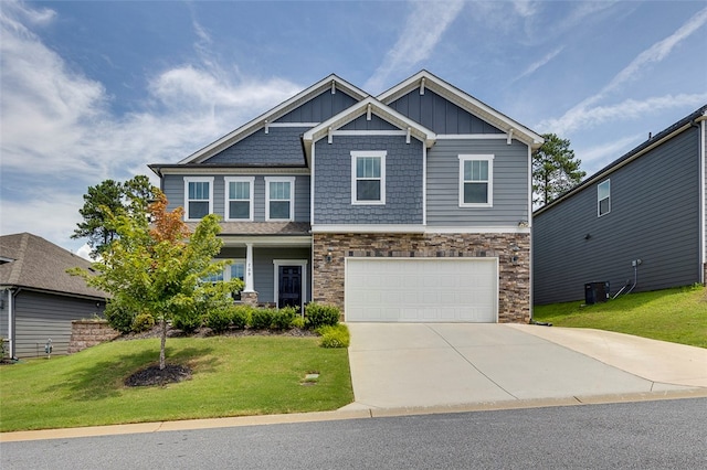 craftsman inspired home featuring a front yard and a garage