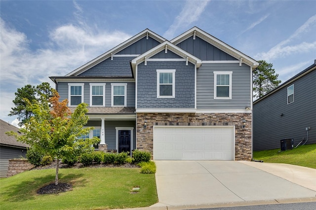 craftsman-style home featuring a front yard and a garage