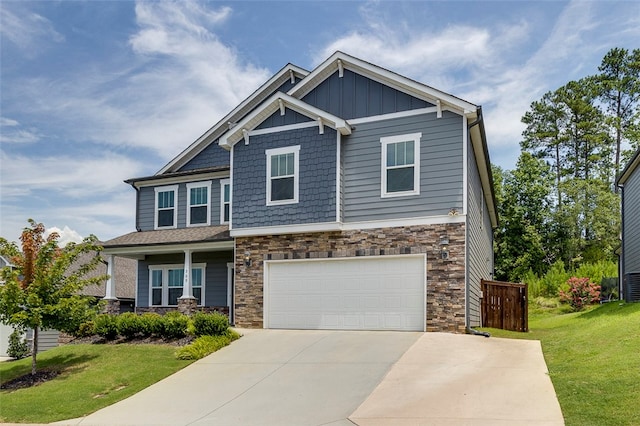 craftsman-style house featuring a front yard and a garage