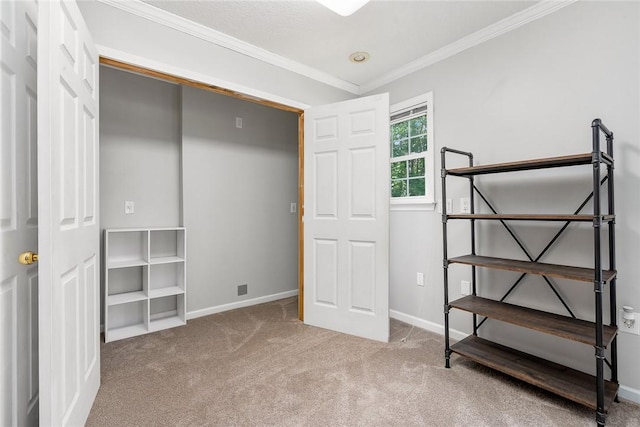 unfurnished bedroom with carpet floors, crown molding, and baseboards