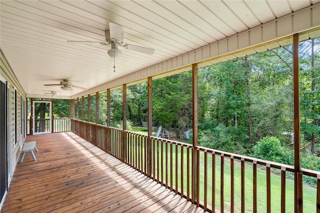 unfurnished sunroom with a ceiling fan