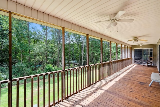 unfurnished sunroom featuring ceiling fan