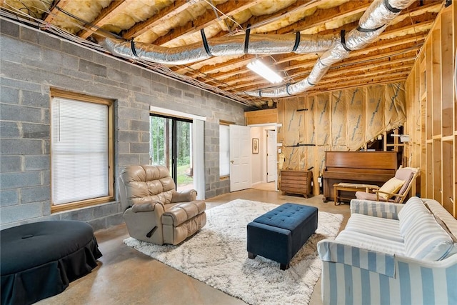 living room with concrete floors and concrete block wall