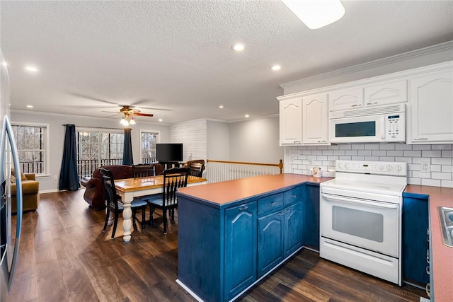 kitchen featuring a peninsula, white appliances, dark wood-style floors, and white cabinets