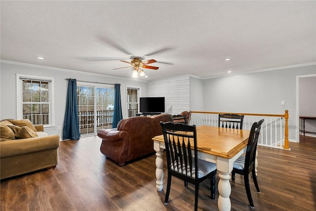 dining area featuring crown molding, a textured ceiling, dark wood-style flooring, and recessed lighting