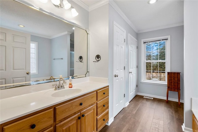 full bathroom with crown molding, recessed lighting, vanity, wood finished floors, and baseboards