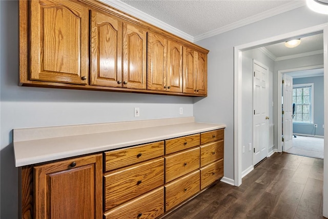 kitchen featuring brown cabinets, light countertops, and dark wood-type flooring