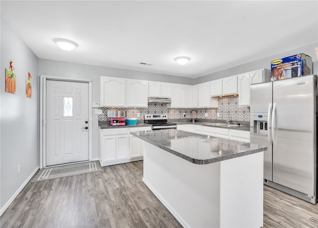 kitchen with sink, a kitchen island, light hardwood / wood-style flooring, white cabinetry, and stainless steel appliances