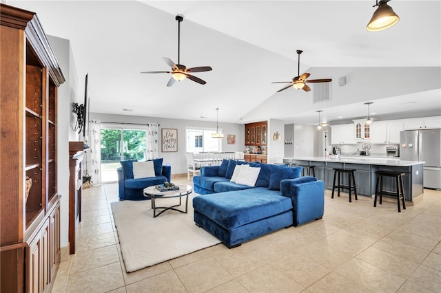 living room featuring ceiling fan, light tile patterned floors, and high vaulted ceiling