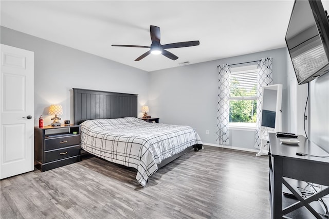 bedroom with wood-type flooring and ceiling fan