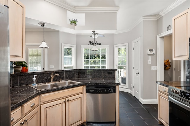 kitchen with light brown cabinets, hanging light fixtures, appliances with stainless steel finishes, sink, and dark tile patterned flooring