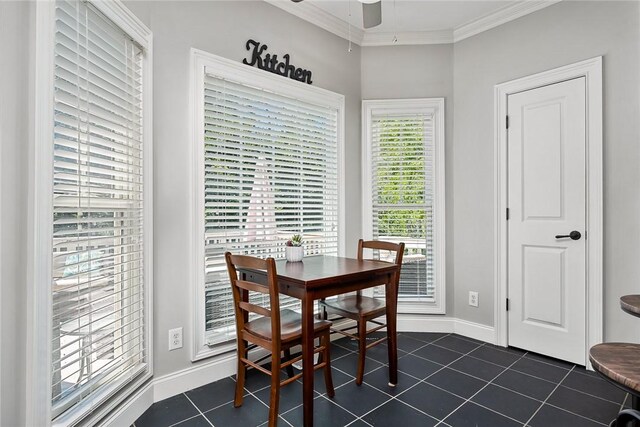 tiled dining area with ceiling fan and ornamental molding