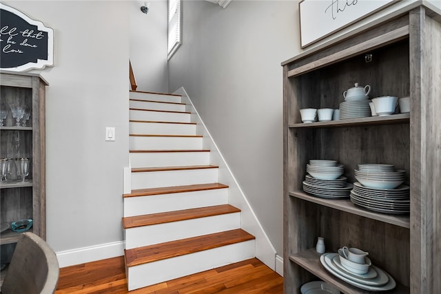 stairs featuring wood-type flooring