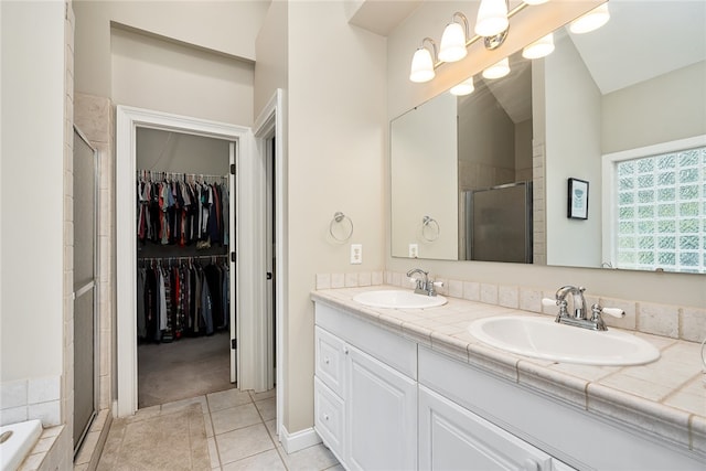 bathroom featuring a notable chandelier, vanity, separate shower and tub, and tile patterned flooring