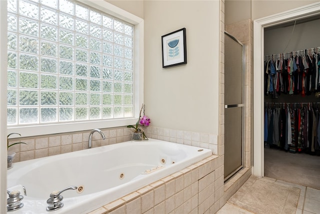 bathroom featuring separate shower and tub and tile patterned flooring