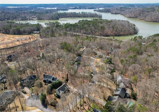 drone / aerial view with a forest view and a water view