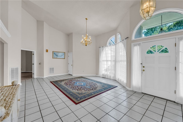 tiled entryway featuring a towering ceiling