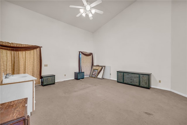 miscellaneous room featuring high vaulted ceiling, carpet, ceiling fan, and sink