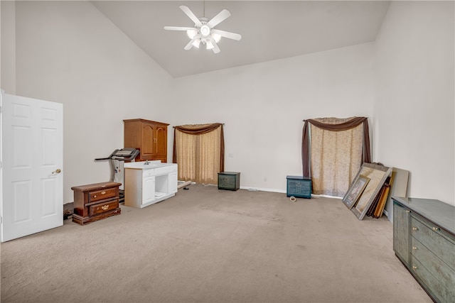 miscellaneous room featuring light carpet, ceiling fan, and high vaulted ceiling