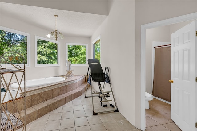 interior space with an inviting chandelier, a textured ceiling, and light tile patterned flooring