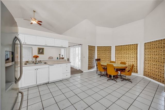 kitchen with high vaulted ceiling, white cabinets, white dishwasher, stainless steel refrigerator with ice dispenser, and sink