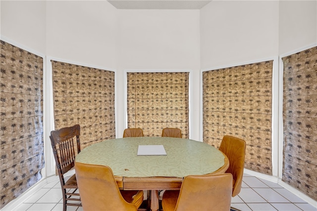 tiled dining area with a high ceiling