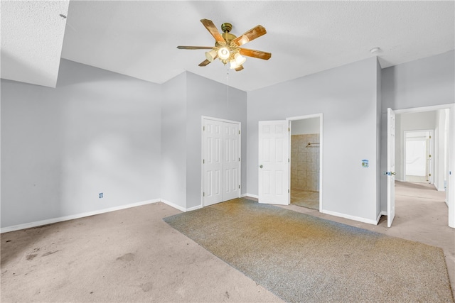 unfurnished bedroom featuring ceiling fan, a textured ceiling, a closet, and carpet