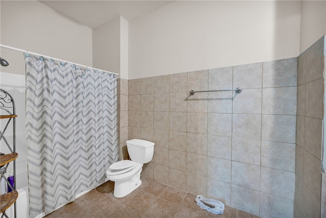 bathroom with tile walls, a shower with curtain, tile patterned floors, and toilet