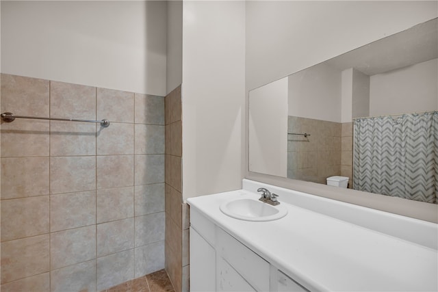 bathroom with toilet, vanity, and a shower with shower curtain