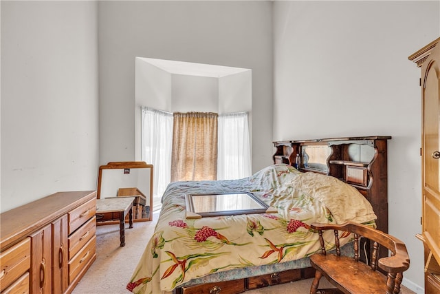 bedroom featuring light carpet